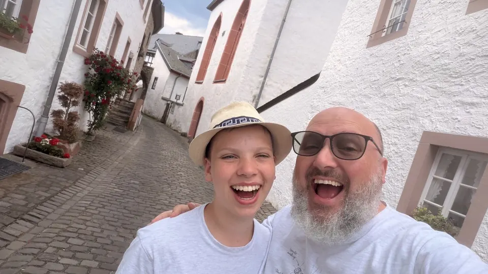 Verdi and Tygo smiling in a village street